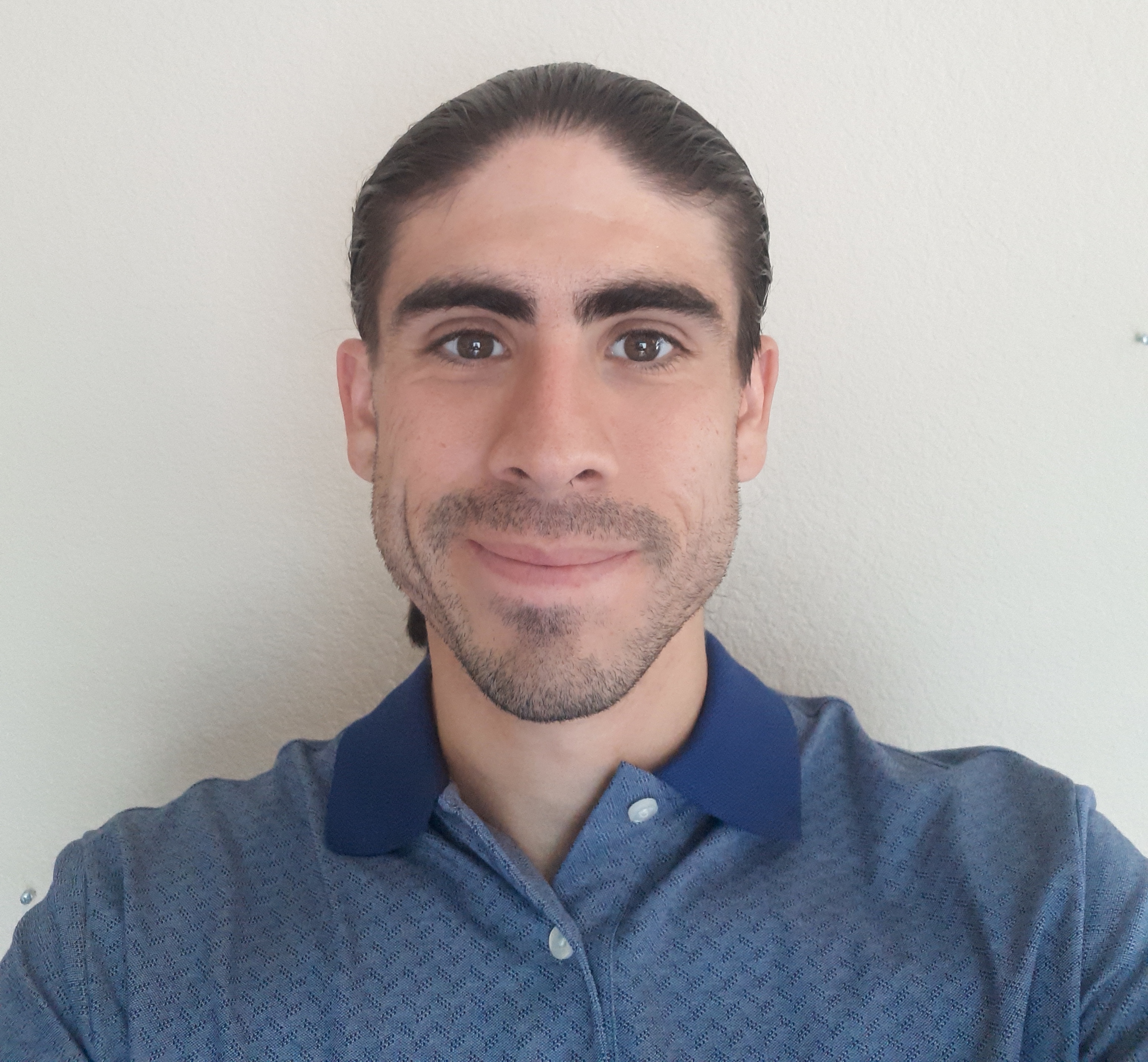 A picture of the portfolio owner wearing a blue polo.